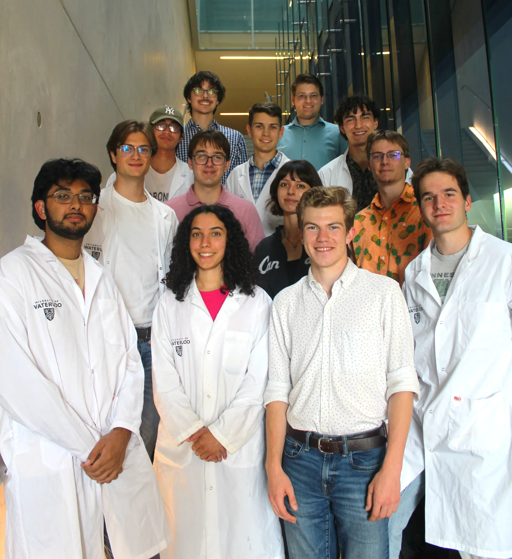 Formula Nano Team Members standing on a set of stairs smiling at the camera